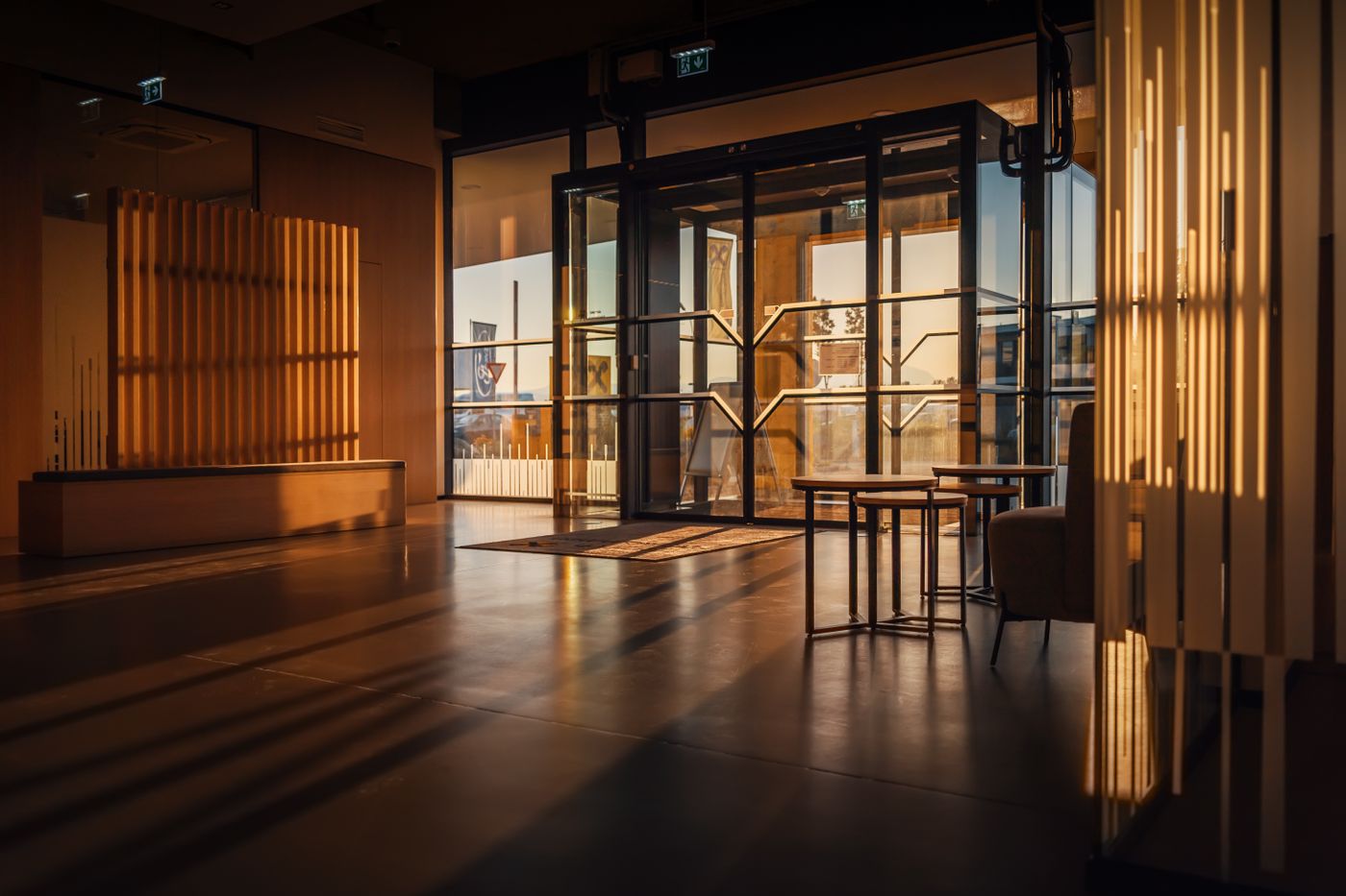 Sunlit modern hotel lobby with glass doors